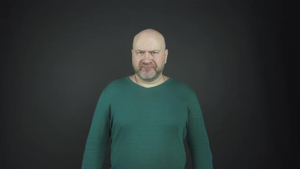 Bald Man with Grey Stubble Performs Emotions of Anger