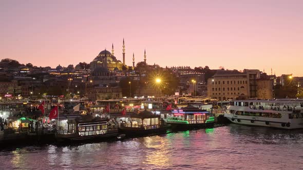 Istanbul Cityscape with Suleymaniye Mosque and Tourist Boats at Night in Turkey