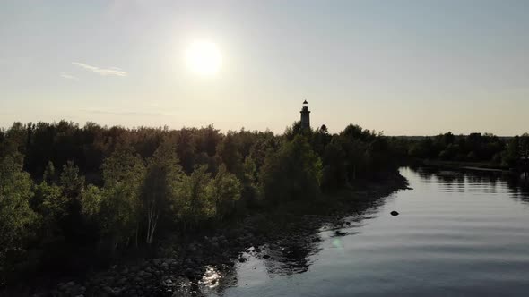 Camera fly low and quick towards old lighthouse on uninhabited island