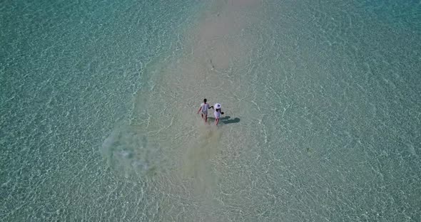 Young boy and girl married on vacation enjoy luxury on beach on summer white sandy 4K background