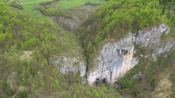 Flying Above a Waterfall and Big Cave Entrance, Romania