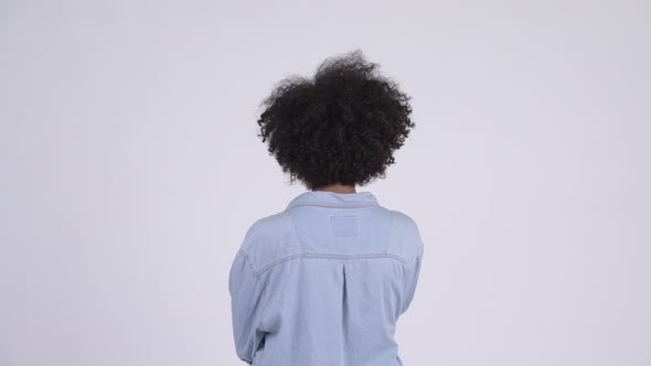 Rear View of Young African Woman Pointing Finger