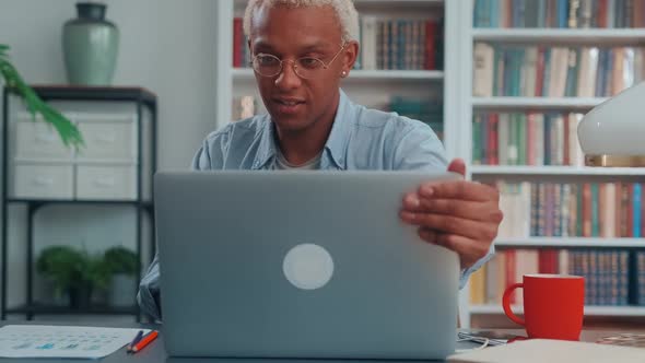 Young African American Man Freelancer with Enthusiasm Working on Laptop