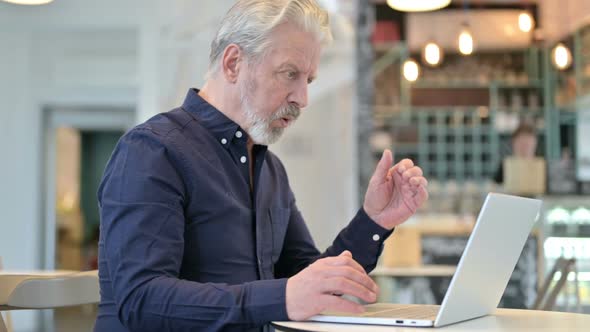 Loss on Laptop By Upset Old Man in Cafe