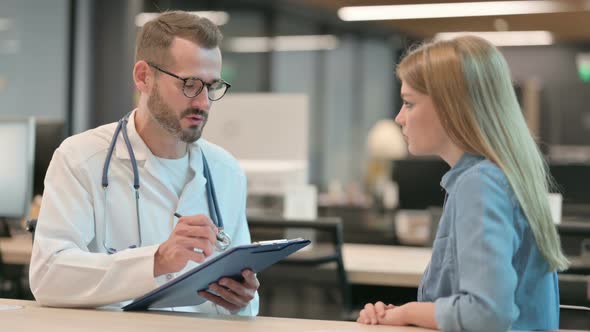 Positive Middle Aged Doctor Talking to Female Patient