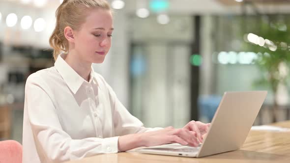 Cheerful Young Businesswoman with Laptop Smiling at Camera 