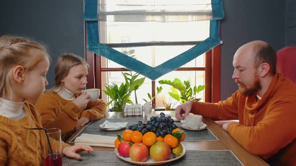 Family Drinking Coffee and Juice