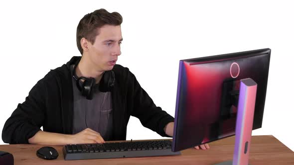 Nervous Man Watching Video Games on a PC Computer on White Background