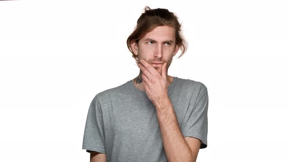 Portrait of Unshaved Guy Posing with Concentrated Look and Hesitating or Trying to Remember Isolated