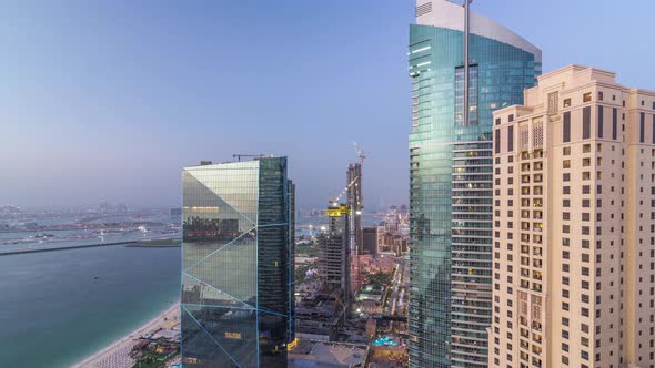 Waterfront Overview Jumeirah Beach Residence JBR Skyline Aerial Day to Night Timelapse with Yacht