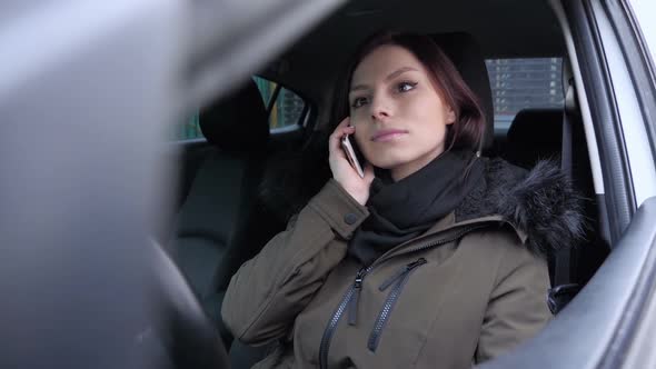 Female Talking on Phone While Sitting in Car