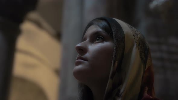 A young woman praying in church