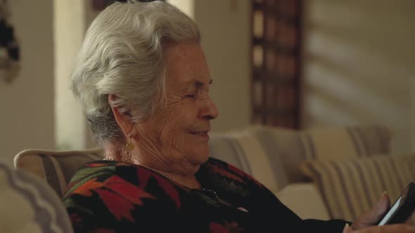 Elderly woman reading digital book