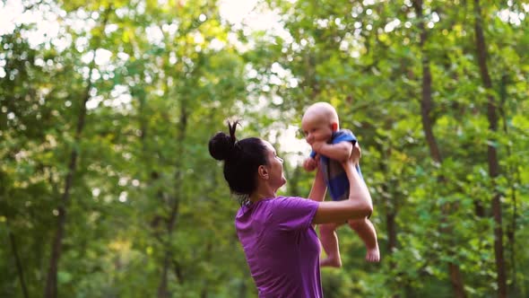 Mother and baby having fun in green park