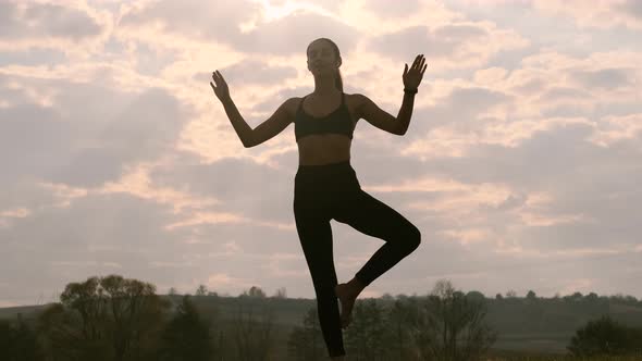 Girl Stands On One Leg.