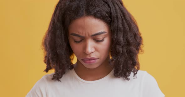 Unhappy African American Woman Looking at Camera with Sad Facial Expression