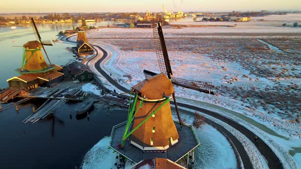 Wooden Wind Mill at the Zaanse Schans Windmill Village During Winter with Snowy Landscape Snow