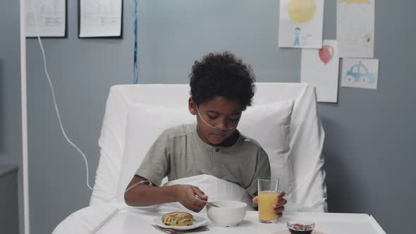 Boy Having Breakfast in Hospital Bed