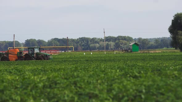 Tractor Is Spraying Fertilizers Field