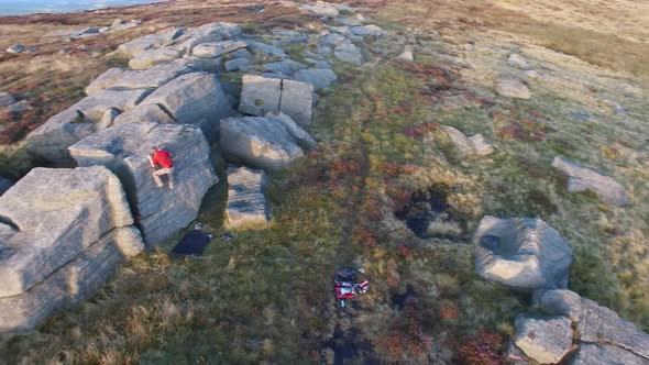 Aerial shot of men climbing boulders while bouldering.