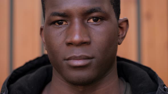 Handsome young black african man staring at camera-outdoor