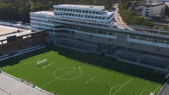 Training football team at Studentarnas Uppsala stadium, Sweden. Aerial sideways