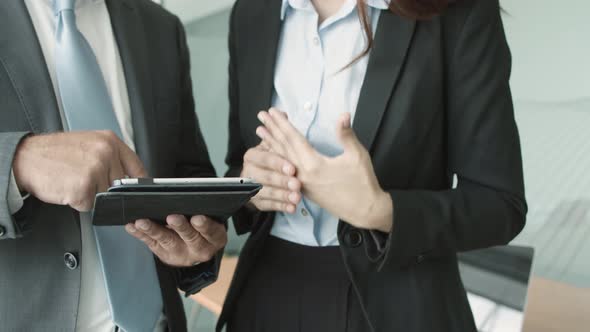 Cropped Shot of Male and Female Colleagues Wearing Suits