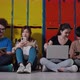 Happy group of student friends use digital tablet, smartphone, computer laptop in in college. - VideoHive Item for Sale