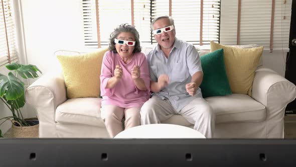 Senior couple watching 3D movie
