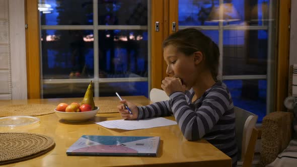 Pretty School Girl at Home, Writing a Homework. Child Sitting at Table and Write a Letter With Pen.