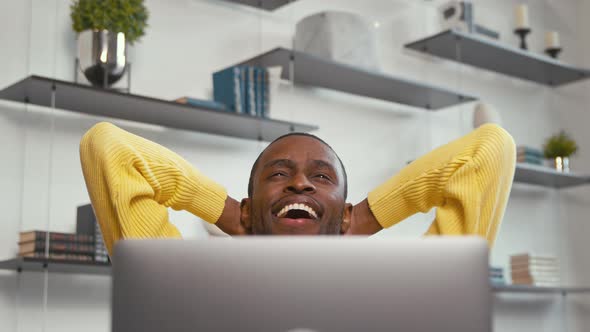 Smiling african freelancer working on computer