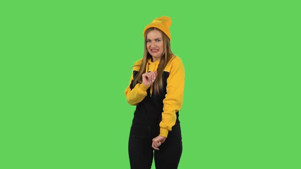 Modern Girl in Yellow Hat Is Showing Disgust for Bad Smell or Taste. Green Screen