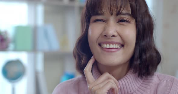 Headshot portrait of young woman laughing and smile with happy