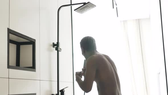 Happy AfricanAmerican Man Sings Having Fun Under Shower