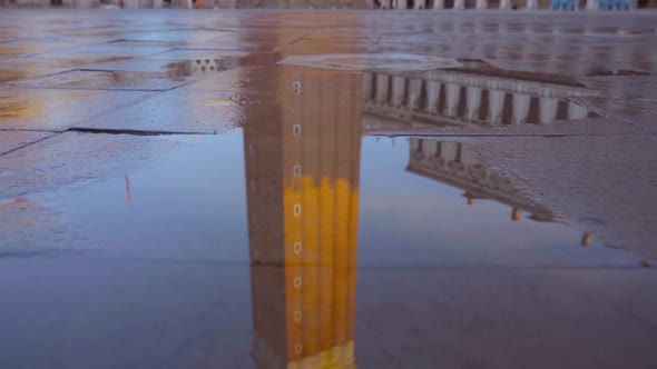 High Bell Tower Reflects on Asphalt Near Doge Palace Museum