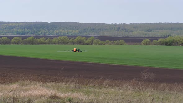 Sowing, Processing of Fields. Pest Control. Trailer Sprayer in Operation.