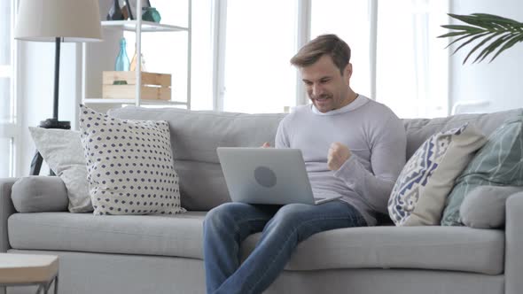 Excited Adult Man Celebrating Success, Working on Laptop