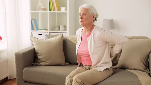 Senior Woman Suffering From Pain in Back at Home