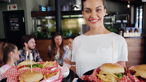 Waitress presenting food in restaurant