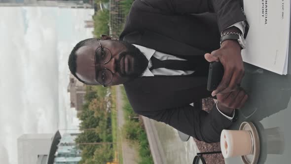 Vertical Portrait of Businessman in Outdoor Cafe