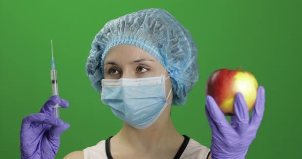 Female Scientist Chooses Syringe with Medicines or an Apple