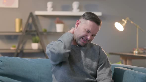 Portrait of Casual Man Having Neck Pain