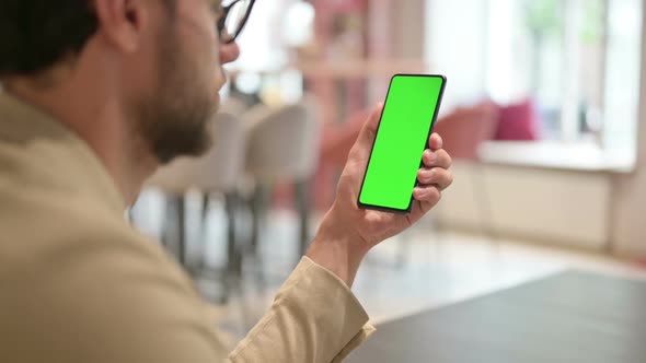 Young Man Using Smartphone with Chroma Screen