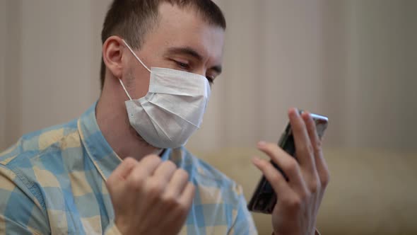 Man Wearing Medical Mask at Work From Home