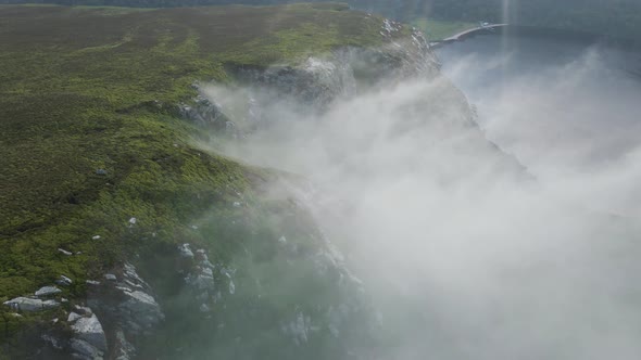 Incredible stunning cliff fog Wicklow mountains Lough Tay lake