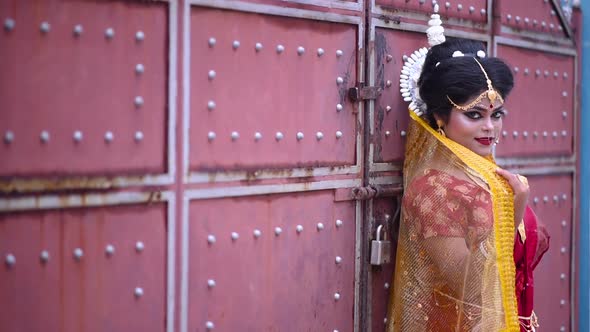 Beautiful Indian Bengali bride smiles at camera