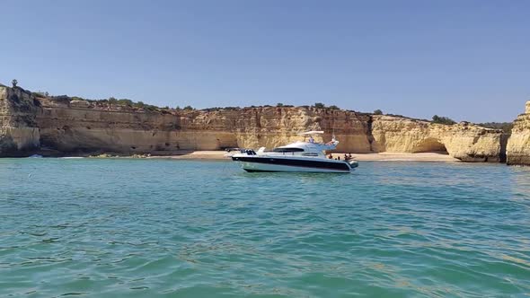 Yacht close to the Algarve rocky coast