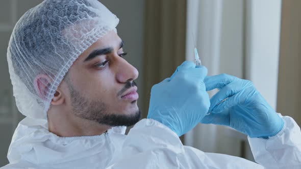 Young Arabic Male Hispanic Doctor Practitioner Surgeon in Special Medical Protective Uniform Wears