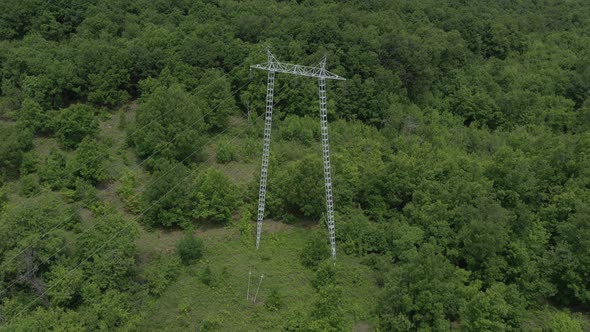 Electricity transmission tower in the forest 4K aerial video