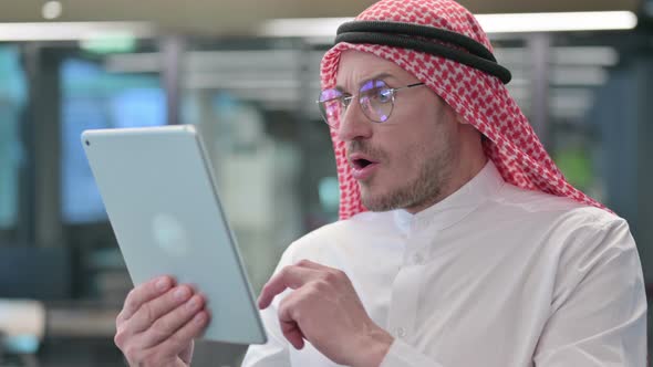 Middle Aged Arab Man Reactig to Loss on Tablet